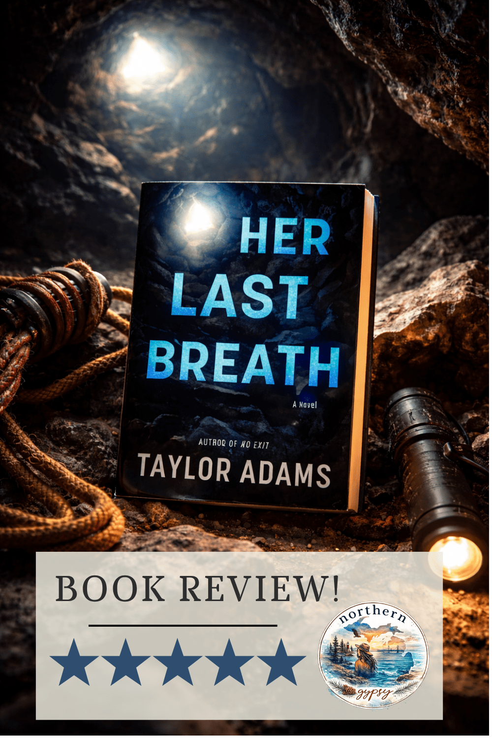 Hardcover copy of Her Last Breath by Taylor Adams styled in a dark cave setting with dramatic lighting and climbing gear